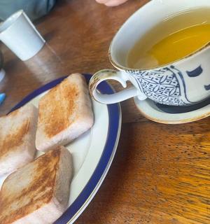 a plate of toast and a cup of tea