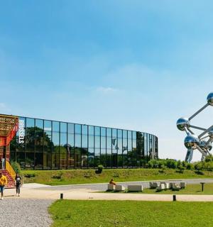 a large glass building with people walking in front of it
