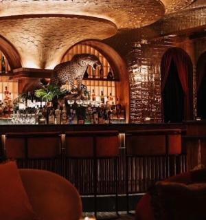 a bar with a bird statue on top of it