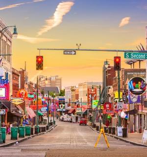 a city street with a traffic light and many signs