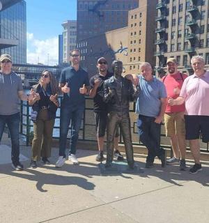 a group of people posing for a picture on a bridge