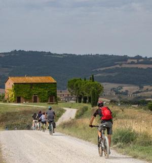 a group of people riding bikes down a dirt road