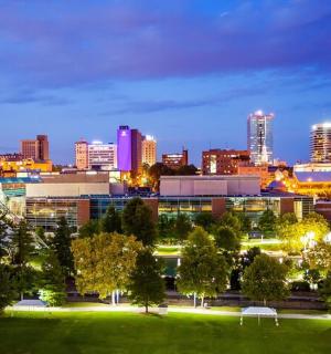 a city skyline at night with a water tower