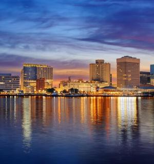 a view of a city skyline at night from the water
