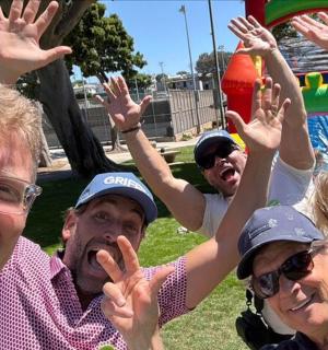 a group of people with their hands in the air