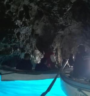 a group of people in a boat in a cave