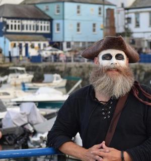 a man with a white face with ahat on