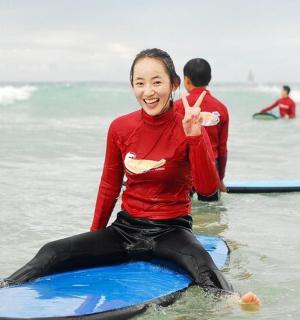 a woman sitting on a surfboard in the ocean