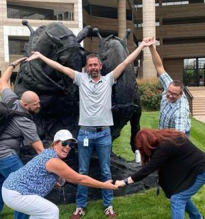 a group of people standing in front of a statue