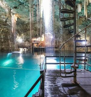 a swimming pool with a ladder in a cave