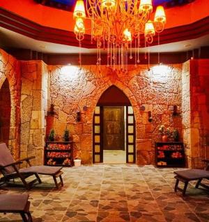 a lobby with a chandelier and chairs in a building