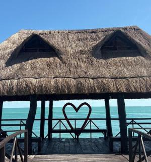 a hut with a heart painted on it on the beach