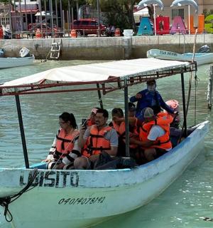 a group of people in a boat in the water
