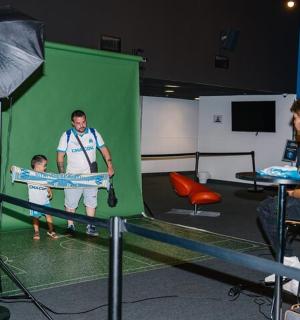 a woman holding a child on a tennis court