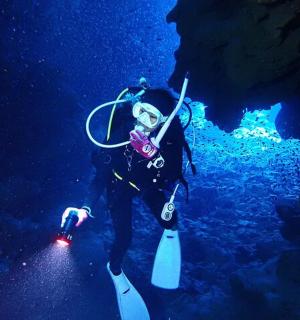 a person is standing in a underwater cave