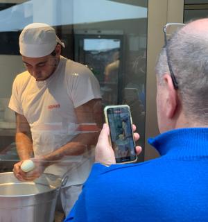 一名男子用手机给厨师拍照