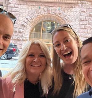 a group of three people posing for a picture