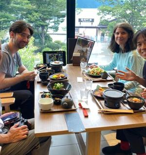 a group of people sitting around a table eating food