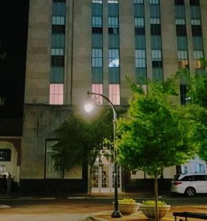 a street light in front of a building at night