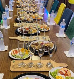 a long table with plates of food and wine glasses