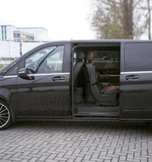 a black van with its door open on a street