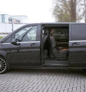 a black van with its door open on a street