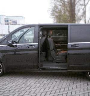 a black van with its door open sitting on a street