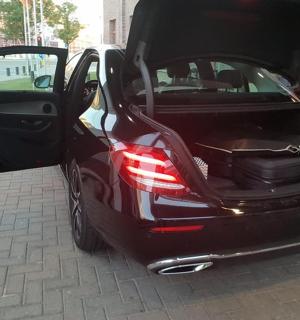 a black car with its door open on a street