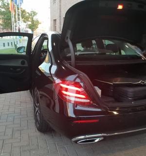 a black car with its doors open on a street