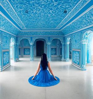 a woman sitting on the floor in a blue room