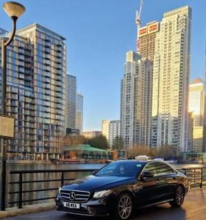 a black car parked on a street in a city
