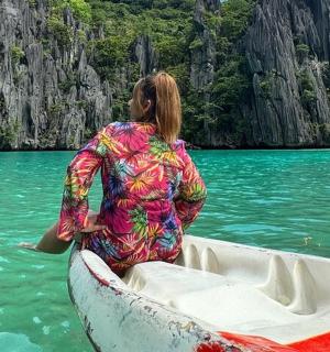 a woman is sitting in a boat in the water