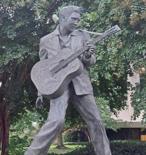 a statue of a man holding a guitar