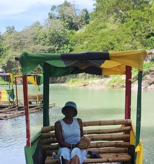 a woman sitting on a boat on a river