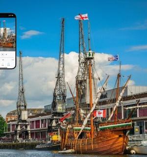 an old boat sitting in the water next to a city