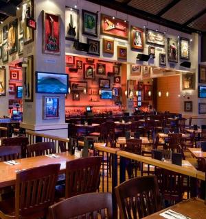 a restaurant with tables and chairs and pictures on the walls