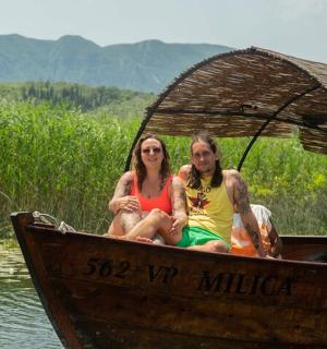two people sitting in a boat on the water