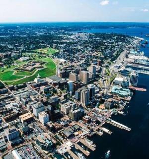 an aerial view of a city next to the water