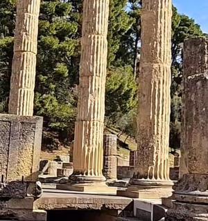 a group of columns in front of some trees