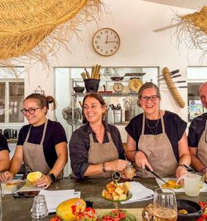 a group of people wearing aprons standing around a table