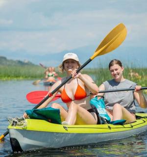 two young people in a kayak on the water