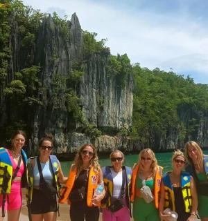 a group of women standing on the beach