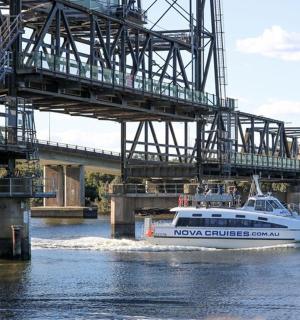 a boat in the water under a bridge