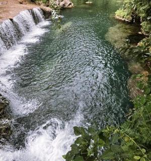 a waterfall in the middle of a river