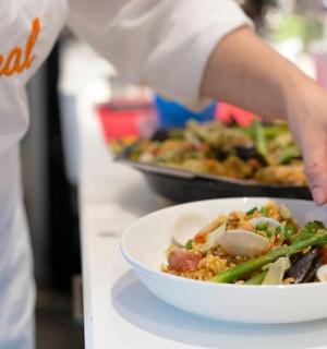 a chef preparing a bowl of food on a counter
