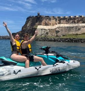 two people riding on a jet ski in the water