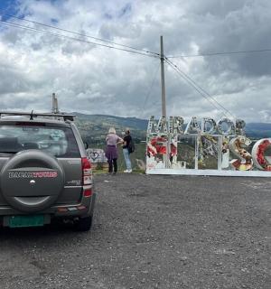 a small suv with a rack on the back of it
