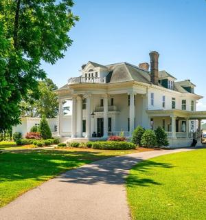 a large white house with a pathway