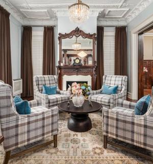 a living room with couches and a table and a fireplace