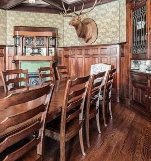 a dining room with a long wooden table and chairs